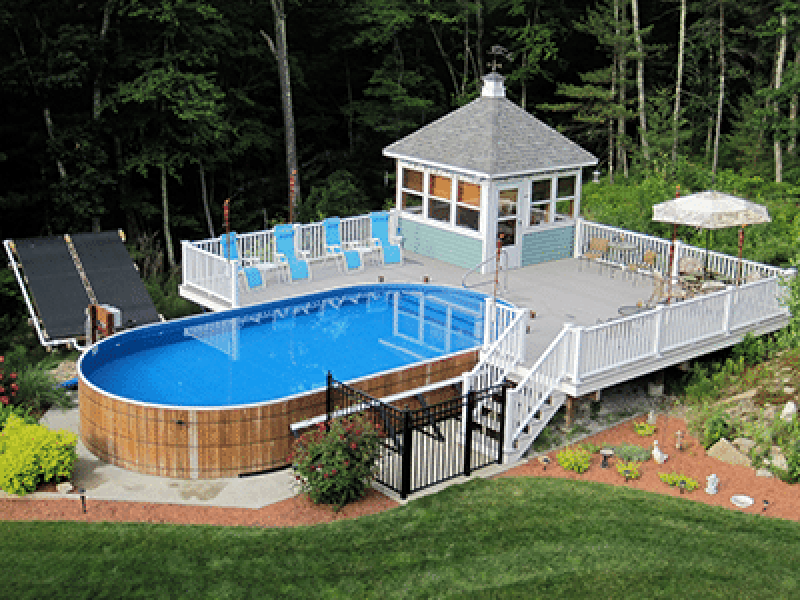 wooden oval above ground pool with deck, cabana and solar panels